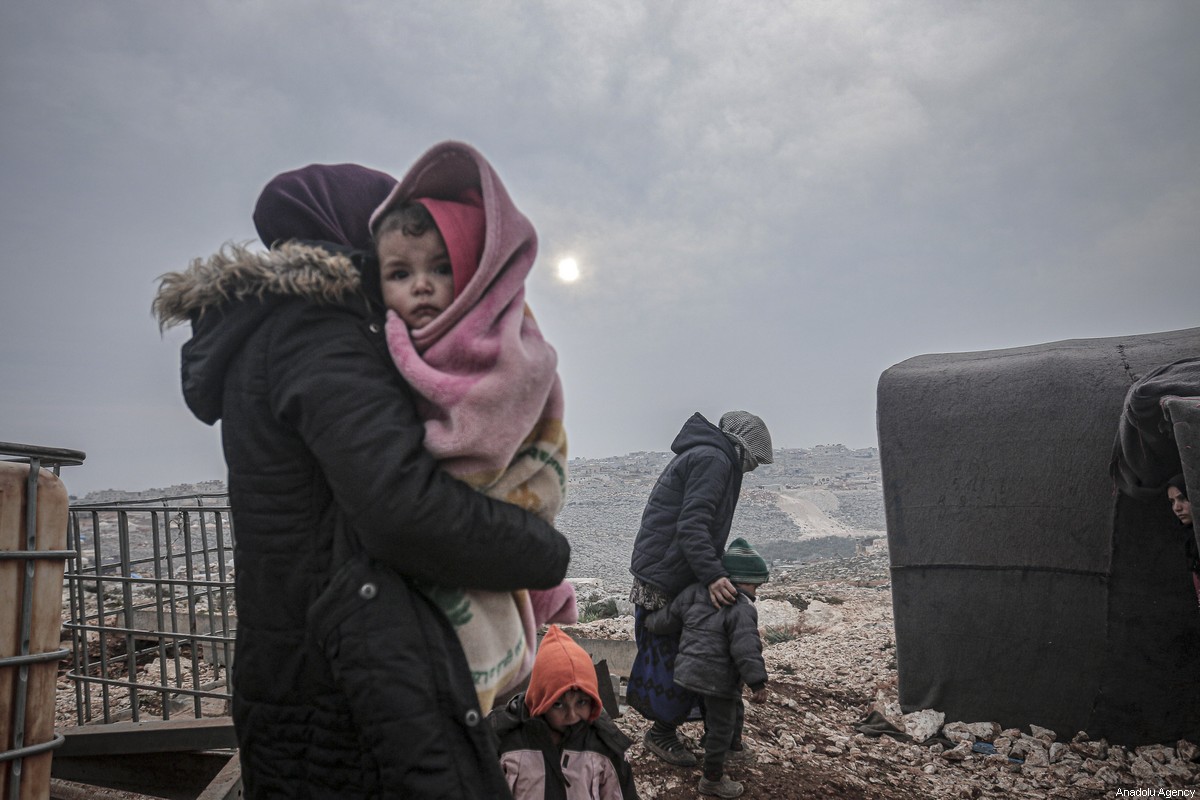 IDLIB, SYRIA - FEBRUARY 14: Syrian families, who have been forcibly displaced due to the ongoing attacks carried out by Assad regime and its allies, are seen at a camp in Turmanin in the western rural of Aleppo near Turkish border on a cold winter day in Idlib, Syria on February 14, 2020. ( Muhammed Said - Anadolu Agency )